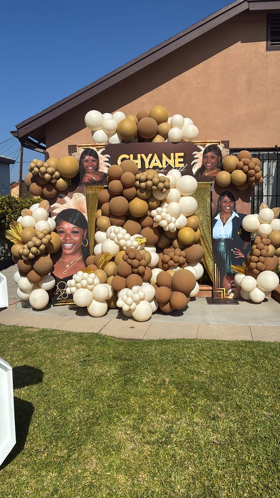 Gold, brown and cream balloon installation backdrop with custom signage by Evalasting Events
