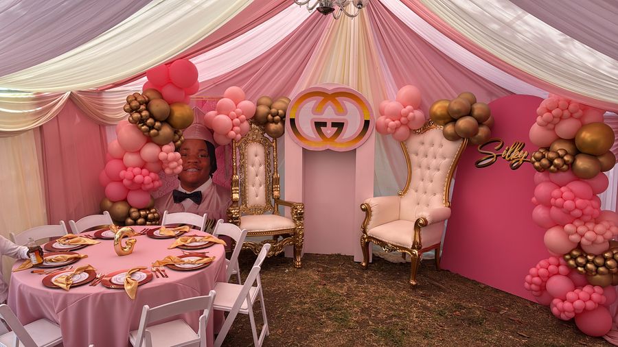 Pink and gold throne celebration with balloon garlands